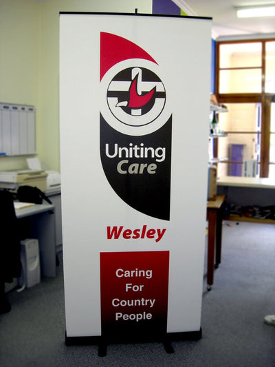 Portable pull up banner stand with sign 2 meters high by 85cm wide, colapses into small base for storage