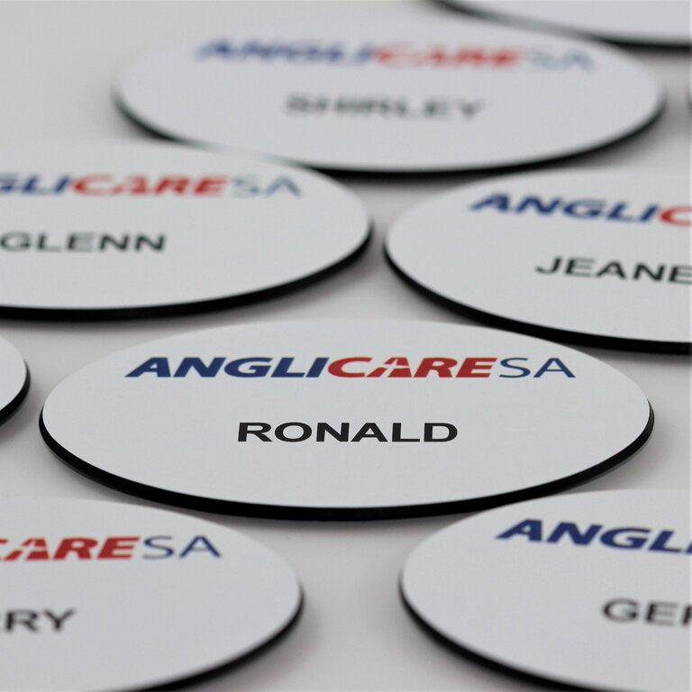 Premium oval shaped name badge, white plastic with black back