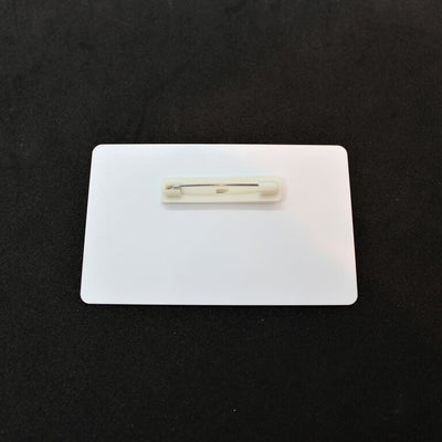 White ID tag with pin backing attachment