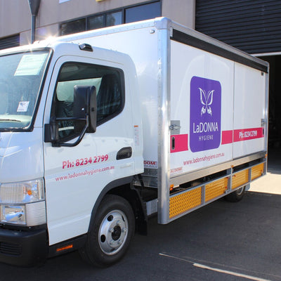 Custom decals on a truck, business logo and name in coloured vinyl matching the customer's brand colours