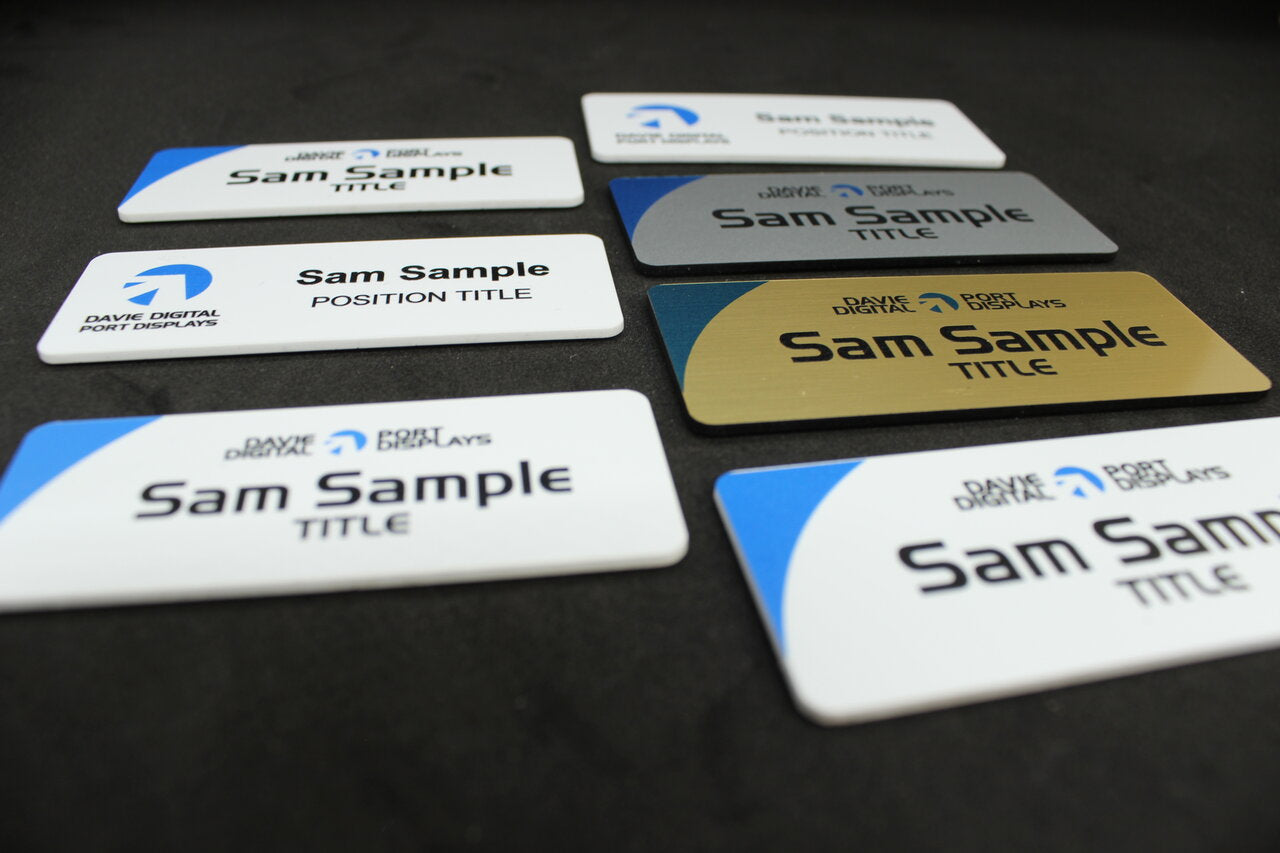 Large name badge in gold, silver or white plastic with company logos in colour print and badge holder's name and position title
