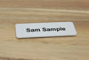 White UV grade plastic name badge in 75x25mm size with pin, magnet or combo clip backing
